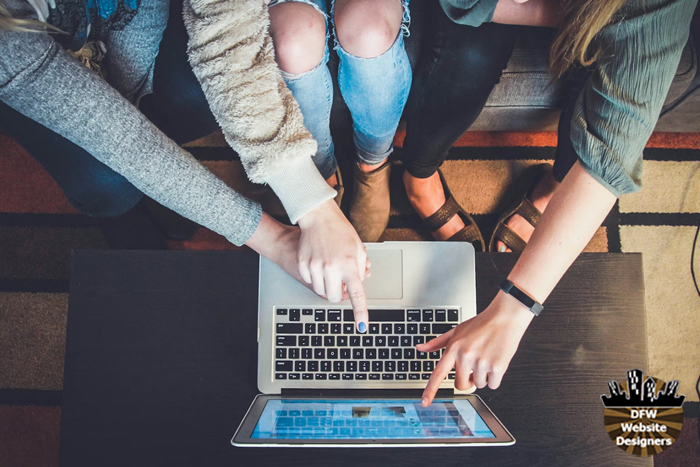 People in front of a computer booking a hotel